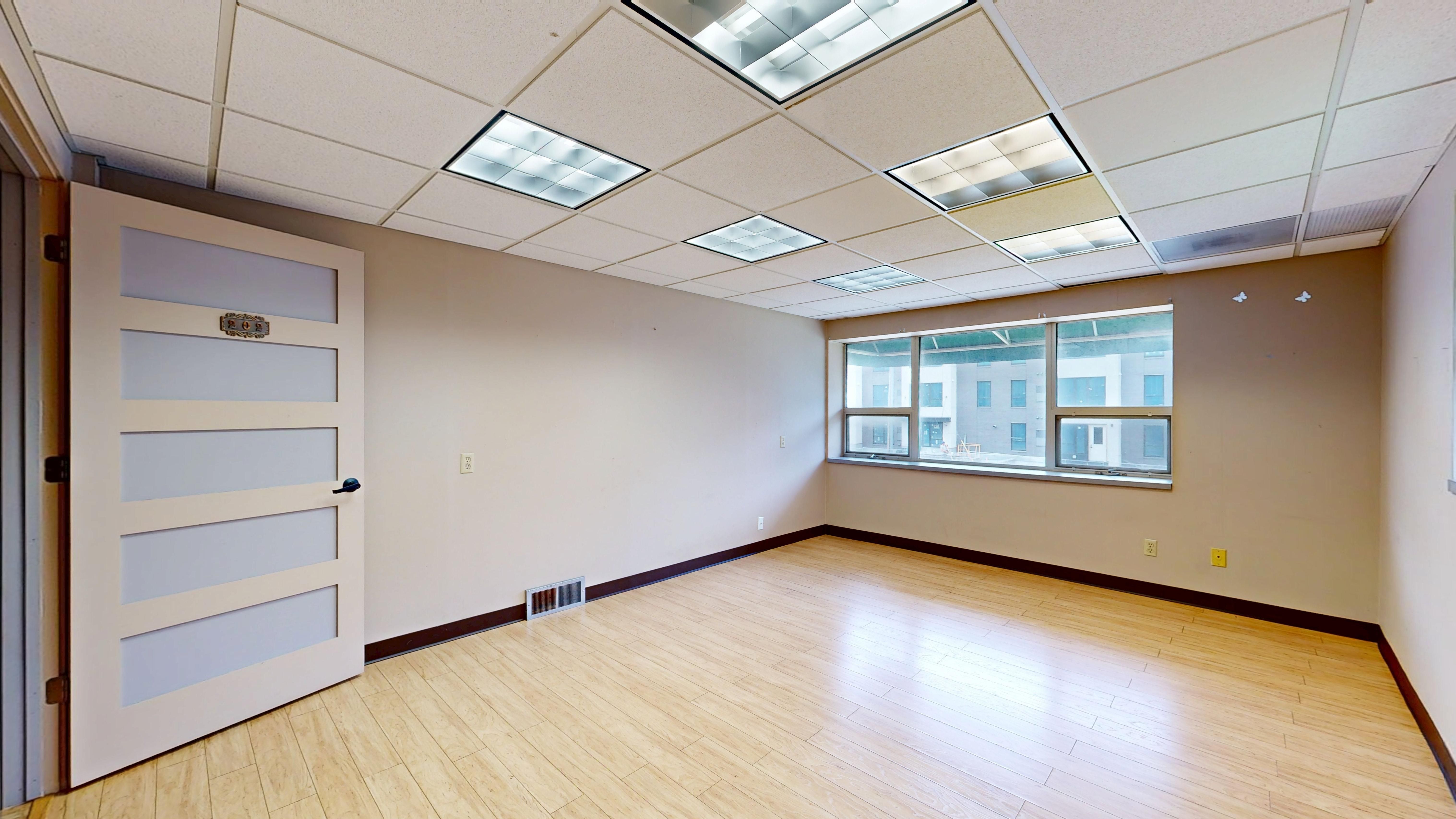 Professional cleaner removing construction dust from a newly finished commercial building
